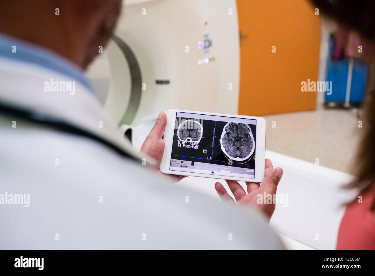 Doctor looking brain mri scan on digital tablet Stock Photo