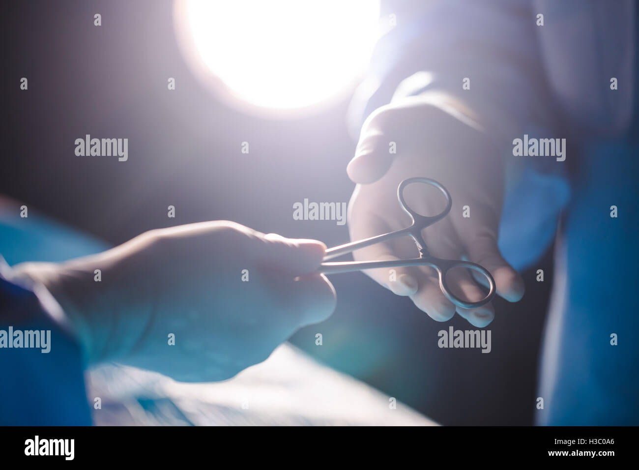 Operating Human Using Razor Knife Surgeons giving operation scissor to colleague in operation room Stock ...