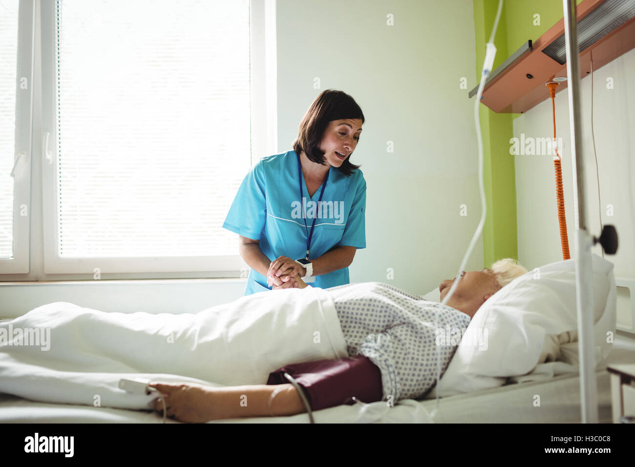 Nurse consoling senior patient Stock Photo
