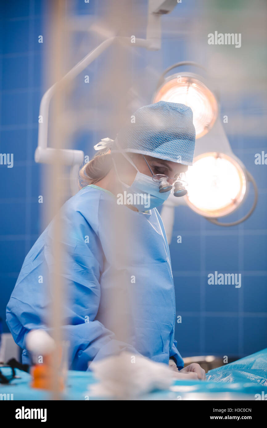 Surgeon performing operation in operation room Stock Photo