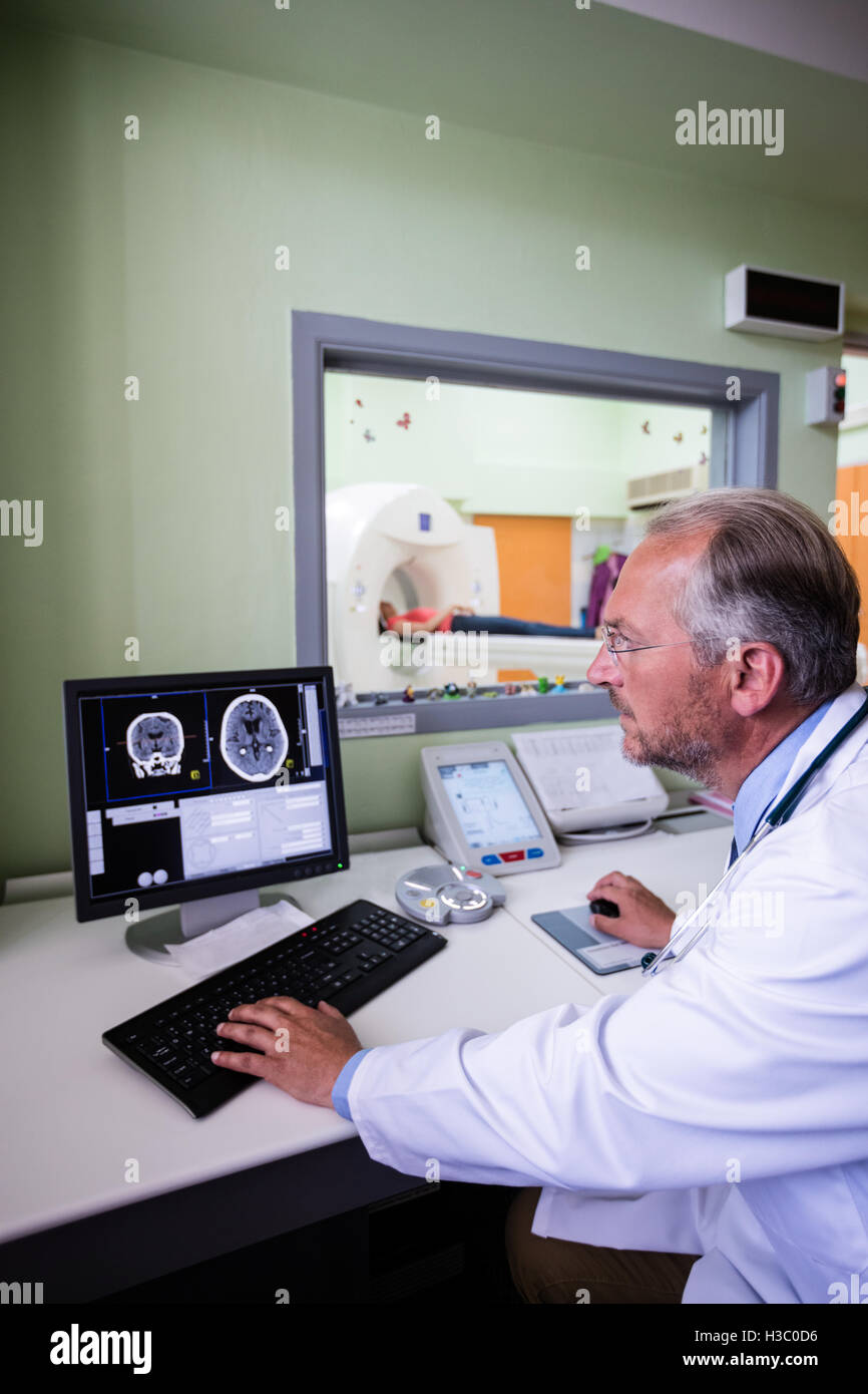Doctor examining brain mri scan on computer Stock Photo