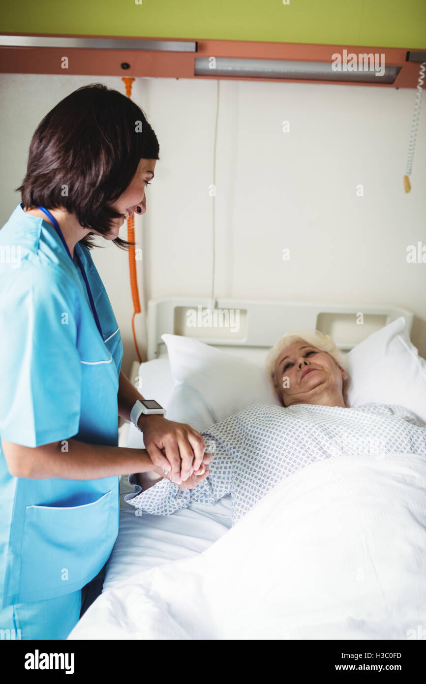 Nurse consoling senior patient Stock Photo