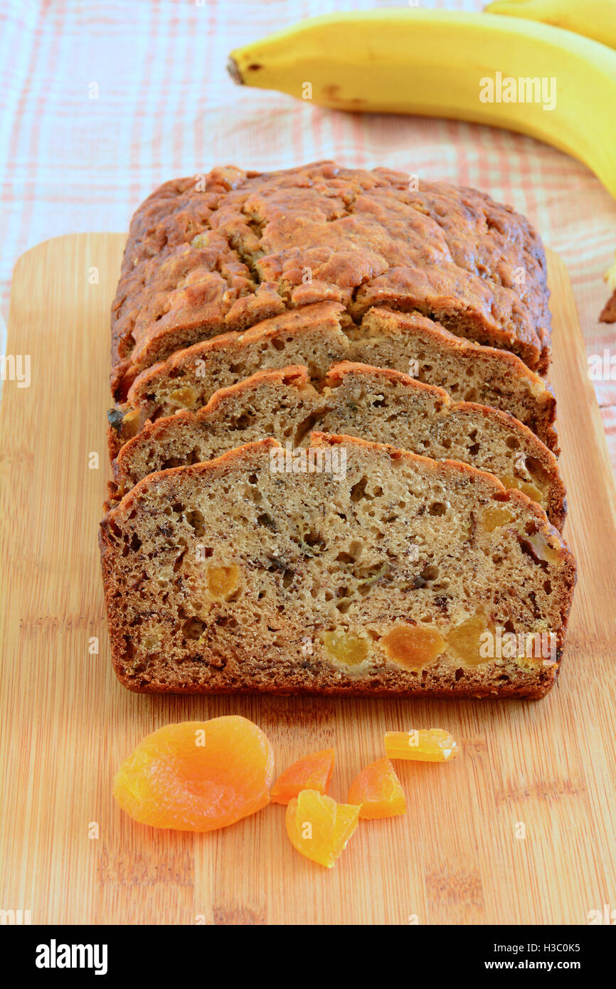 Fresh baked banana bread with sweet apricot pieces in vertical format Stock Photo