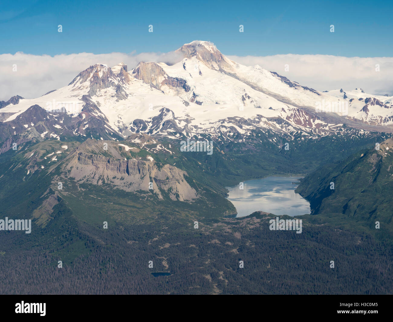 Aerial view of the Iliamna Volcano and Hickerson Lake in the foreground. Lake Clark National Park, Alaska. Stock Photo