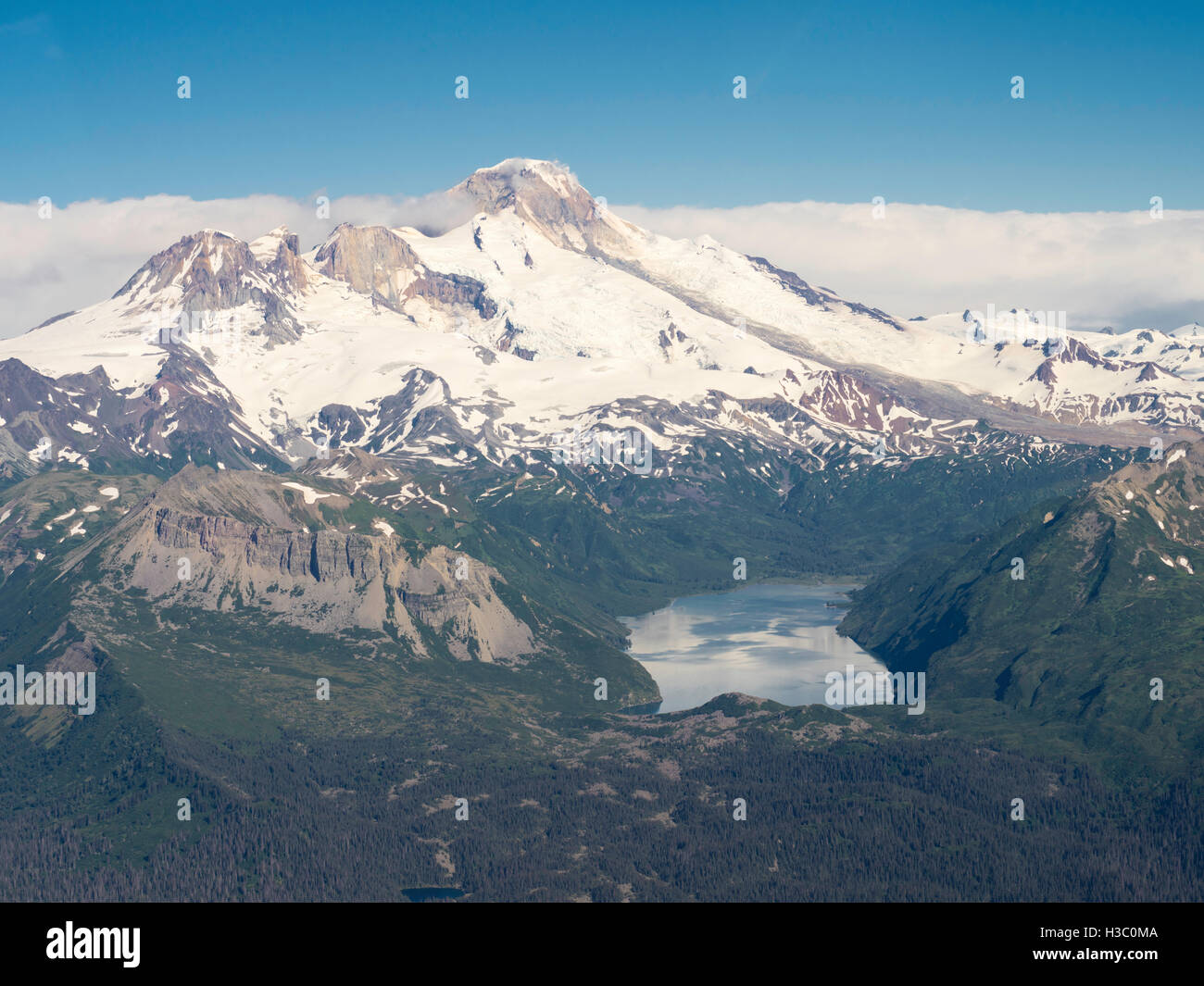 Aerial view of the Iliamna Volcano and Hickerson Lake in the foreground. Lake Clark National Park, Alaska. Stock Photo