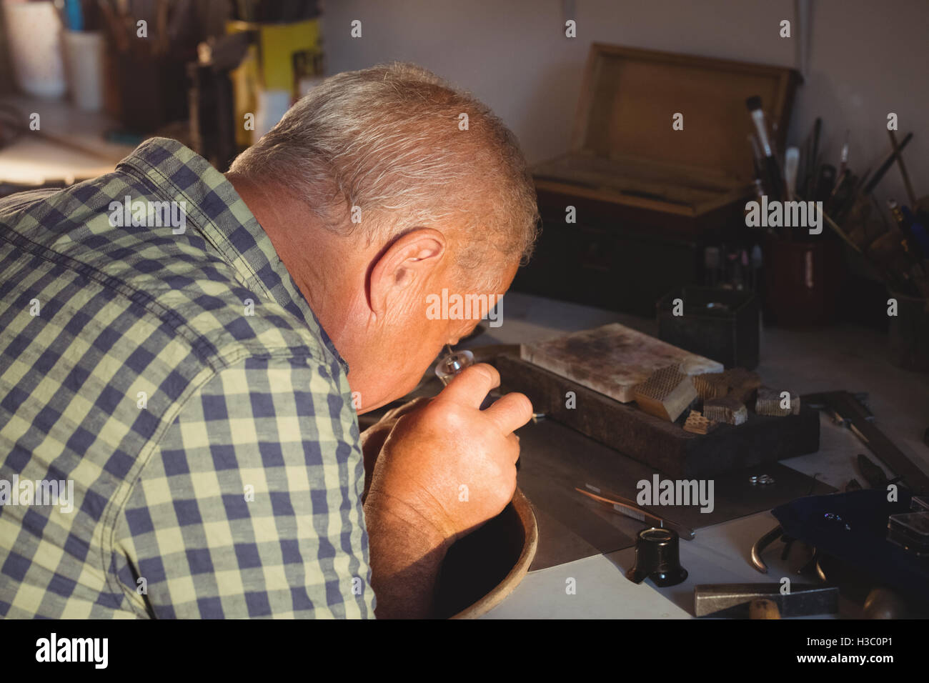 GoldsmithÂ looking through magnifier Stock Photo
