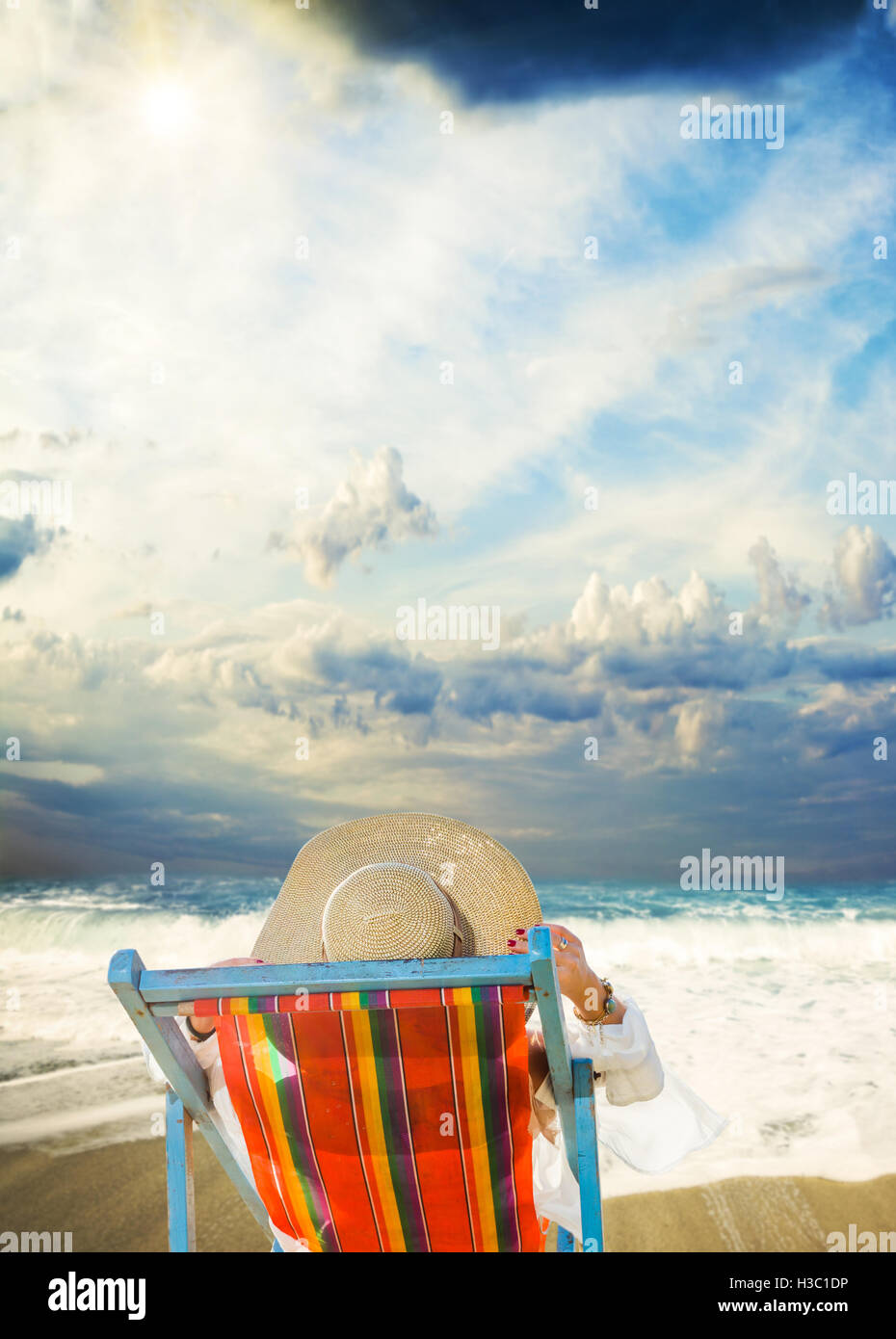 Woman on a tropical beach with hat Stock Photo - Alamy