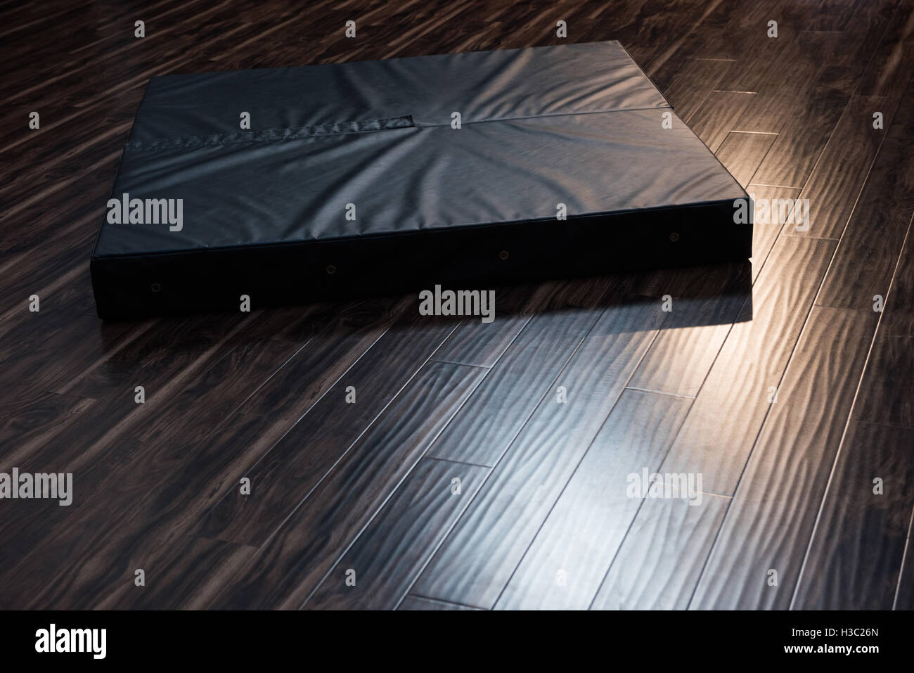 Gymnastics landing mat on wooden floor Stock Photo Alamy