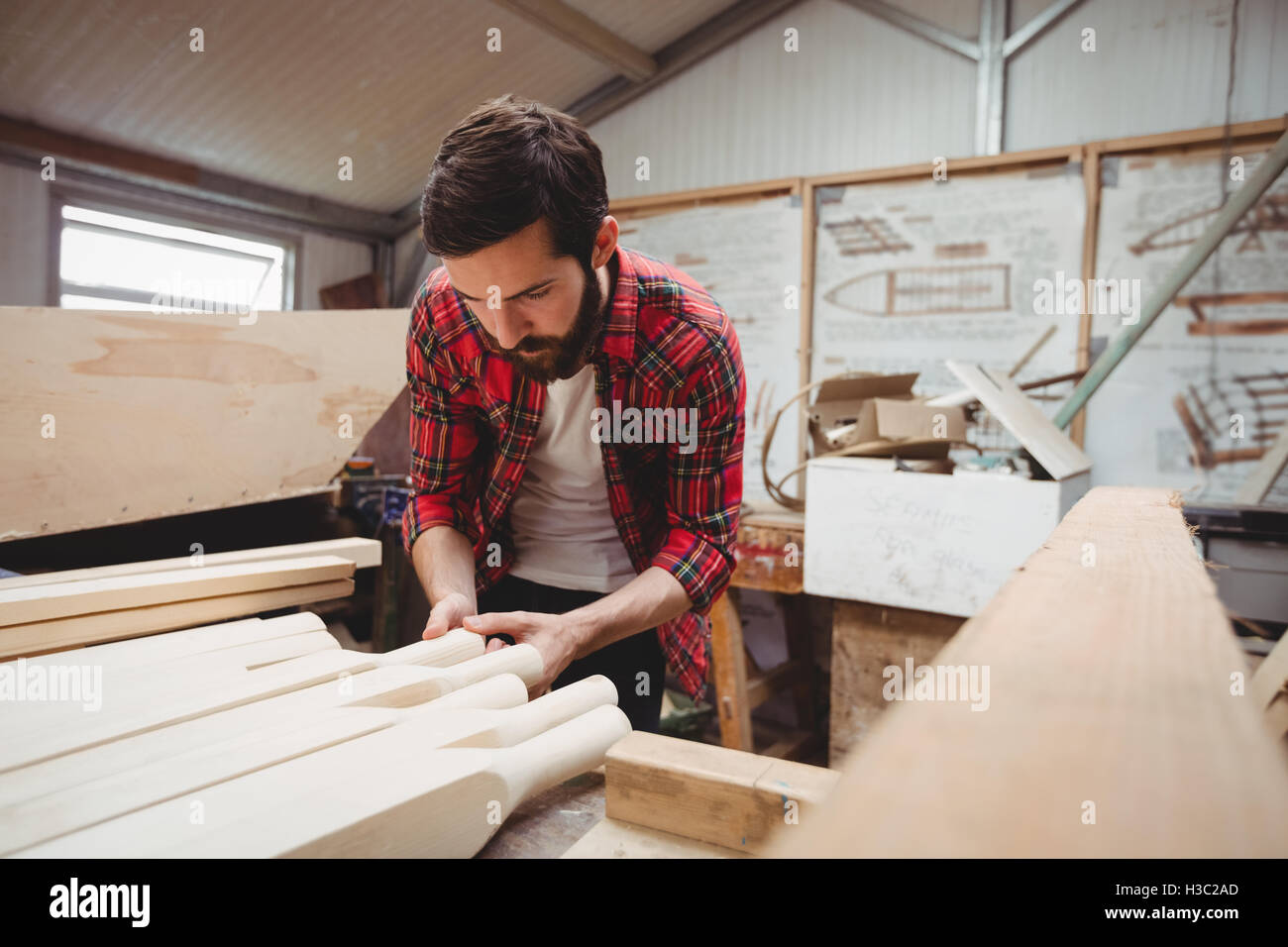 Man working on wooden plank Stock Photo - Alamy