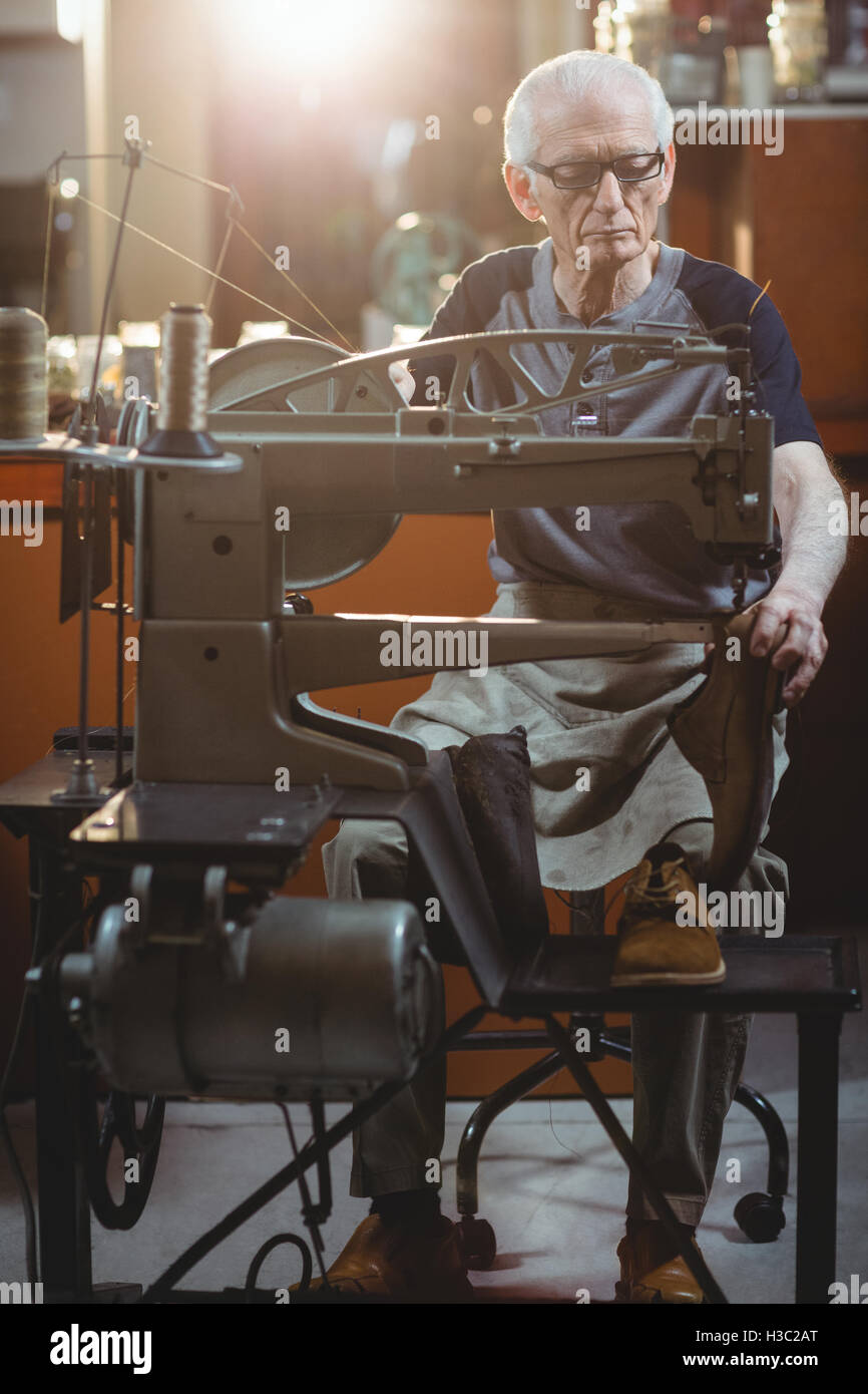 Shoemaker using sewing machine Stock Photo Alamy