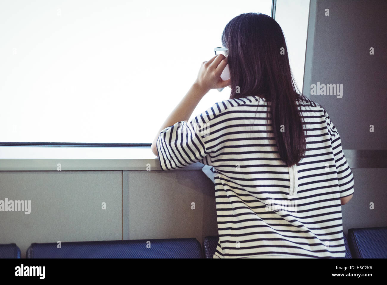 Rear view of woman talking on mobile phone Stock Photo - Alamy