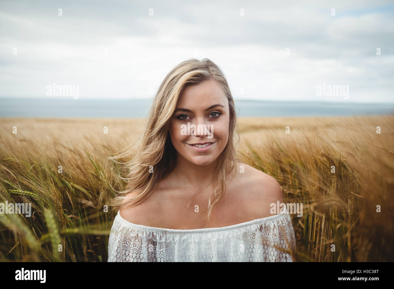 Portrait of smiling woman standing in wheat field Stock Photo - Alamy