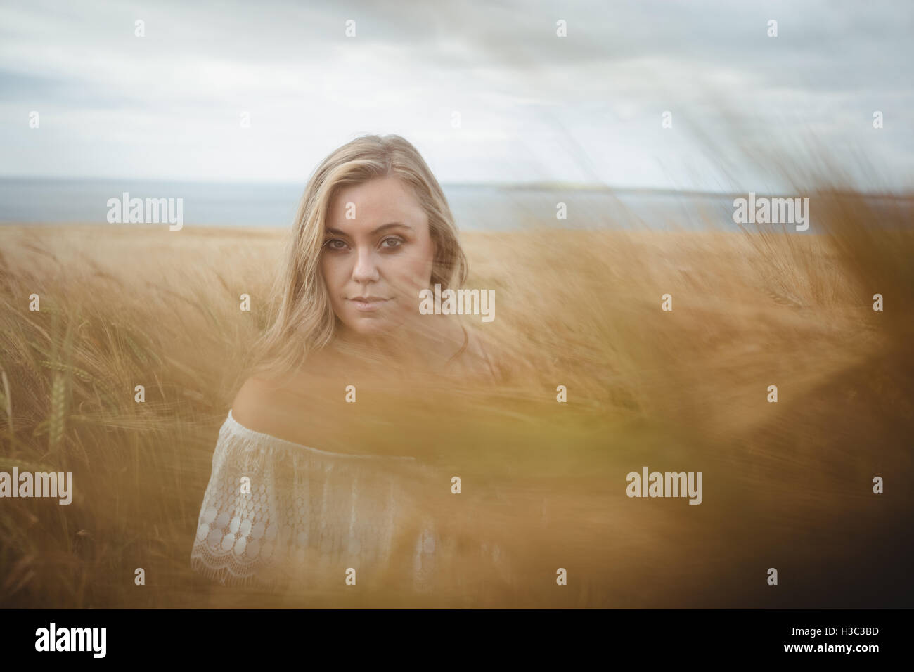 Portrait of woman standing in wheat field Stock Photo - Alamy