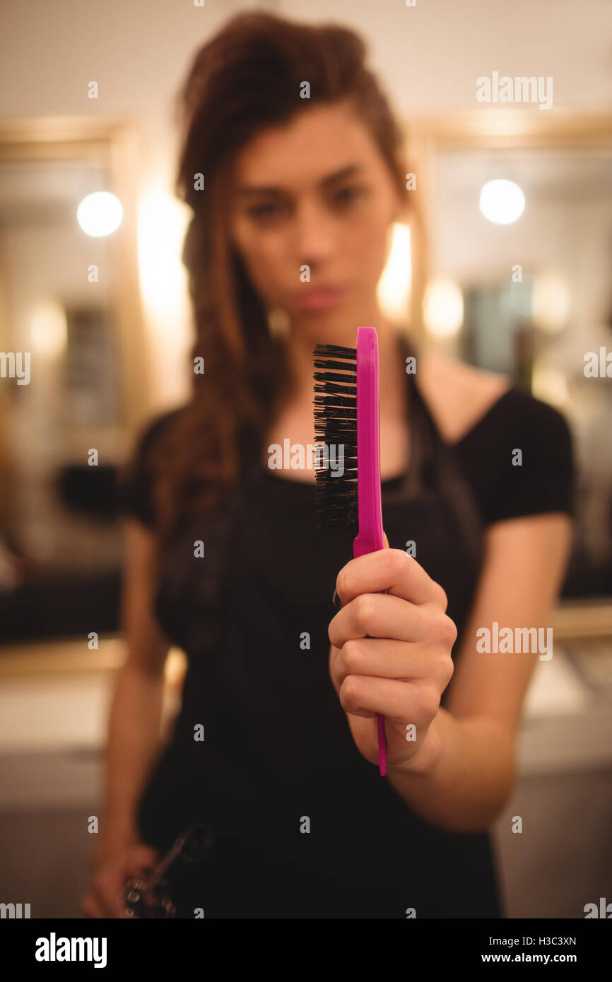 Female hairdresser holding hairbrush Stock Photo Alamy