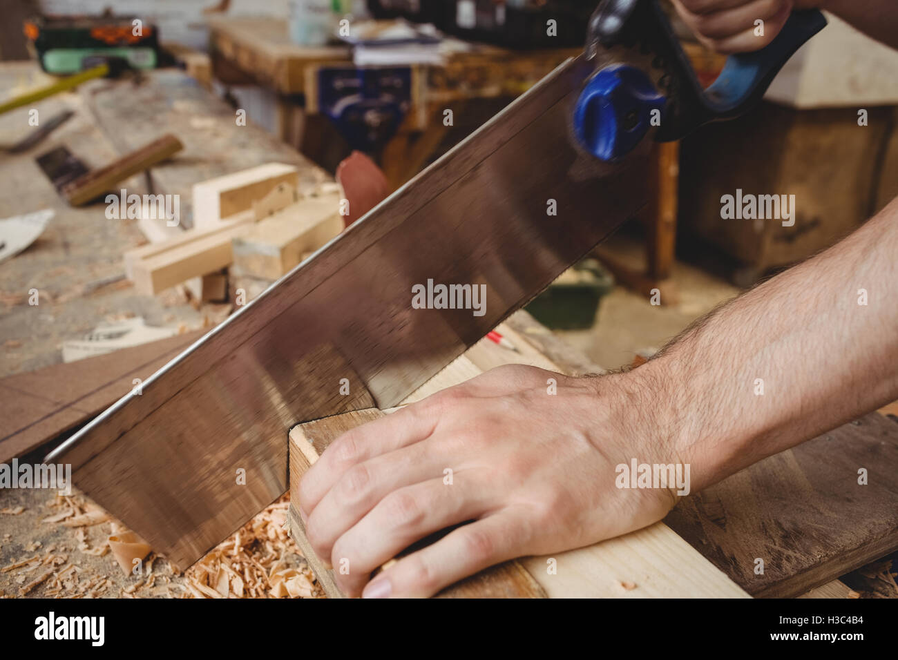 Man cutting a wooden plank Stock Photo Alamy