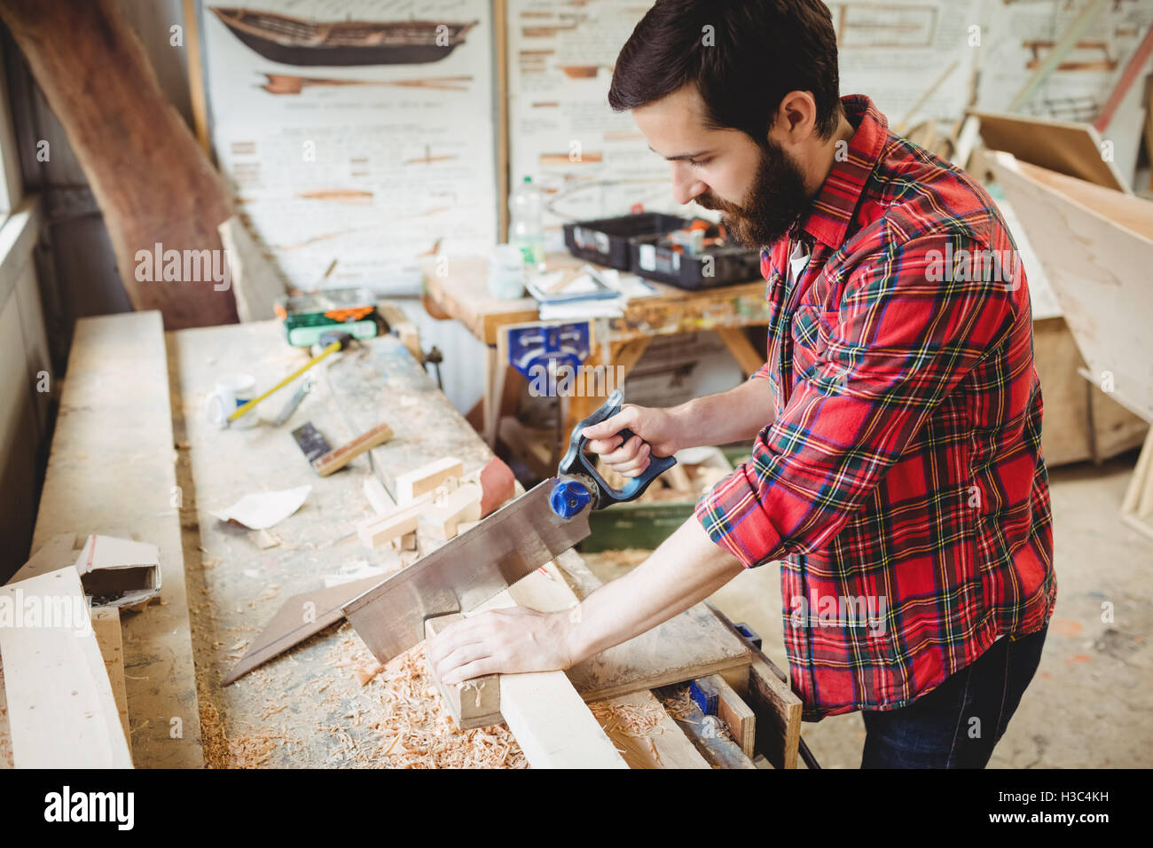 Man cutting a wooden plank Stock Photo Alamy