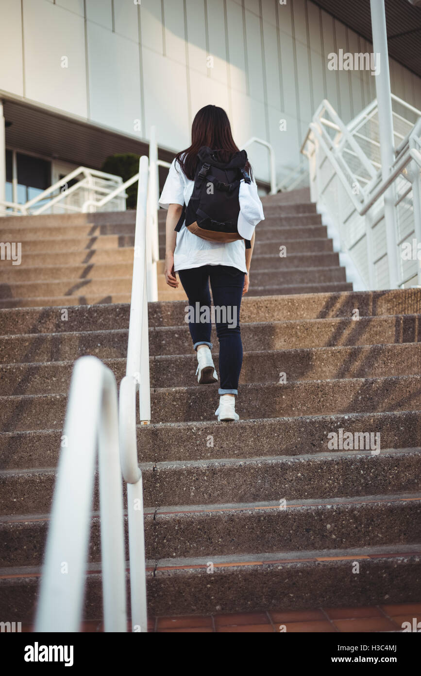 Woman walking up stairs Stock Photo