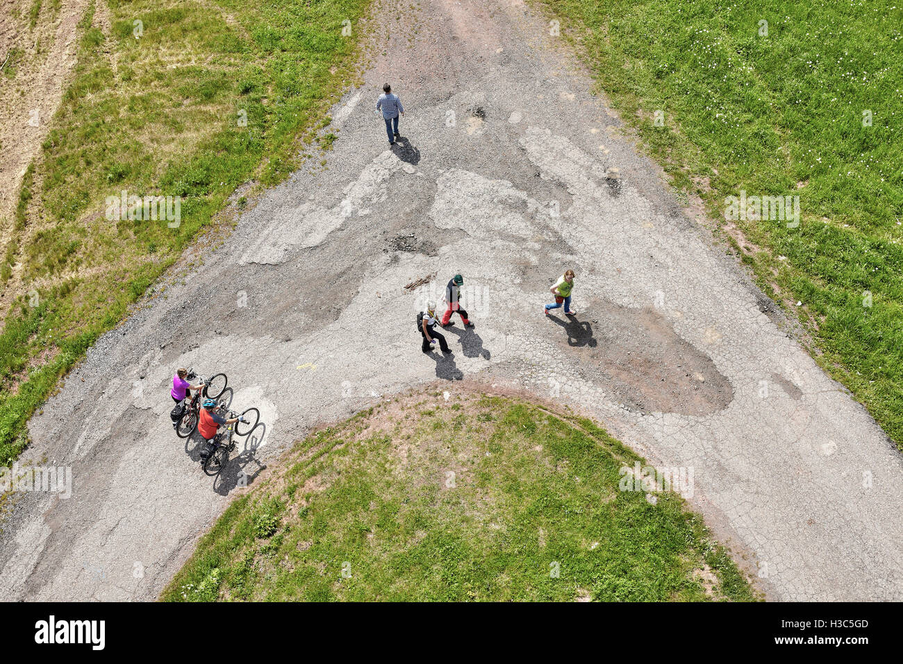 Babi, Czech Republic - May 28, 2016: Aerial picture of a dirt road crossroads with people walking in different directions. Stock Photo