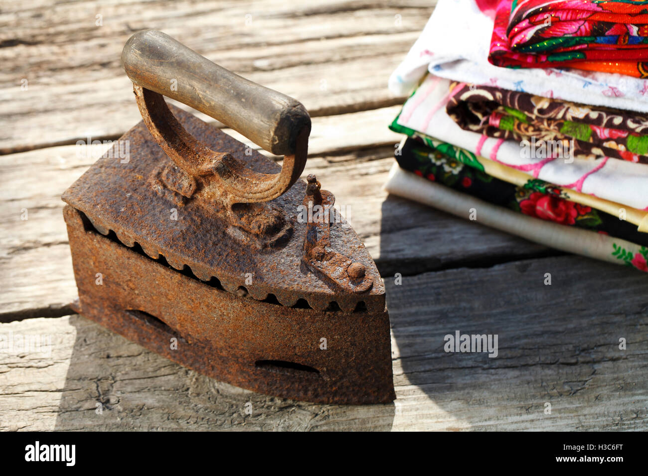 Old vintage iron on the charcoal on wooden background Stock Photo