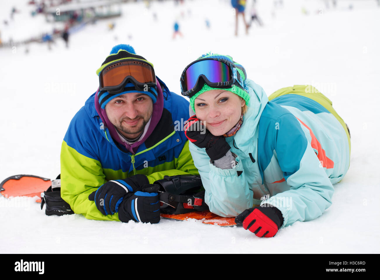 young couple snowboarders rejoice and be glad active recreation Stock Photo