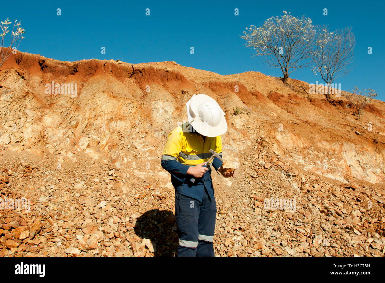 Geologist Hammering Rocks - Australia Stock Photo