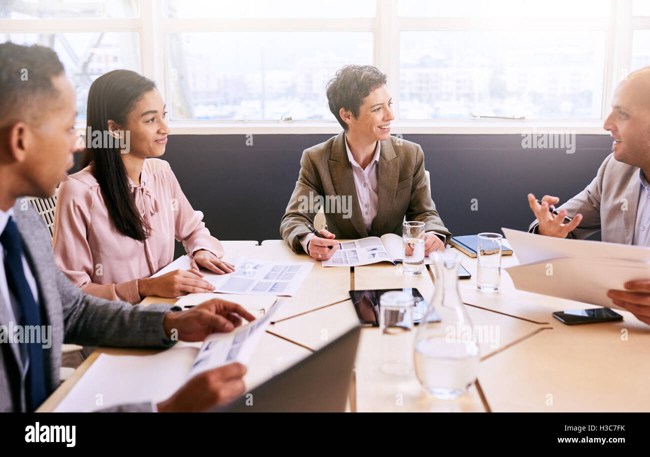Business meeting between four professional executives in conference room Stock Photo