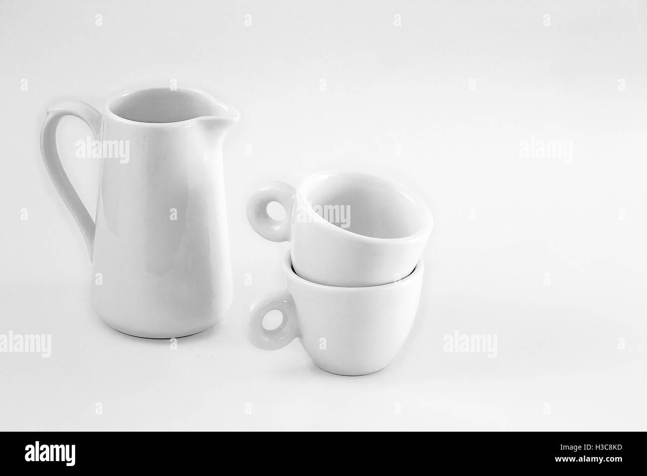 Simple white milk jug and two small cups Stock Photo Alamy