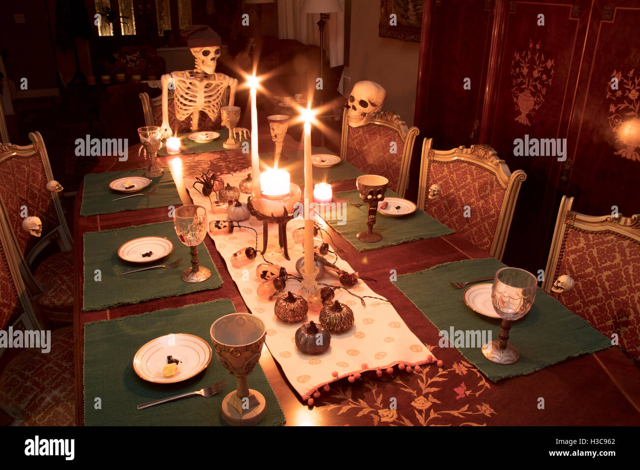 Skeleton family gathered for a Halloween dinner celebrating the Stock