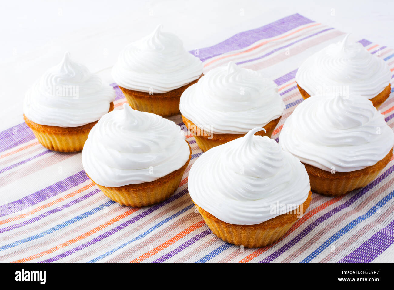 Cupcakes with white whipped cream . Homemade cupcakes with whipped
