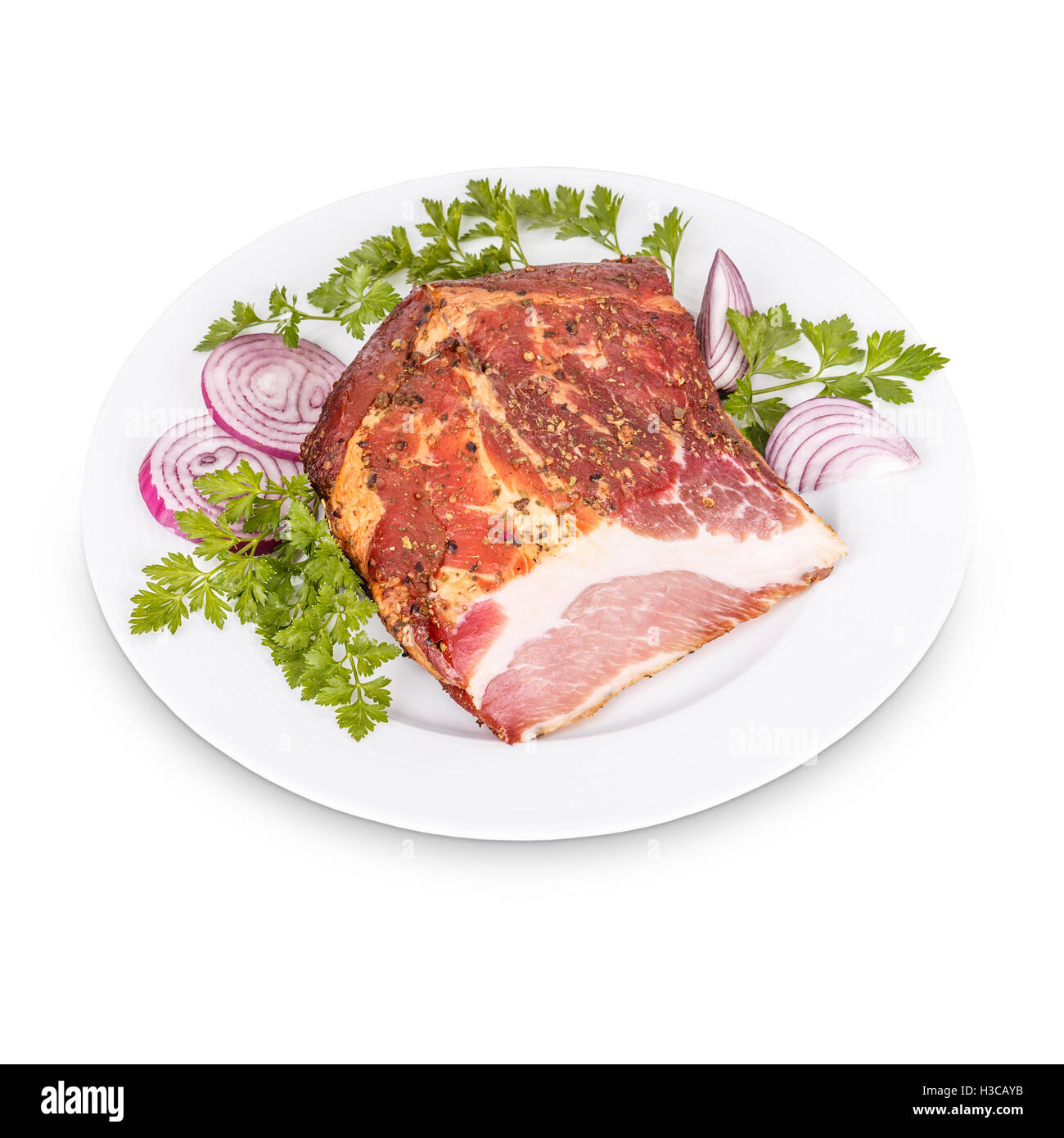 Piece of smoked pork meat on white plate Stock Photo