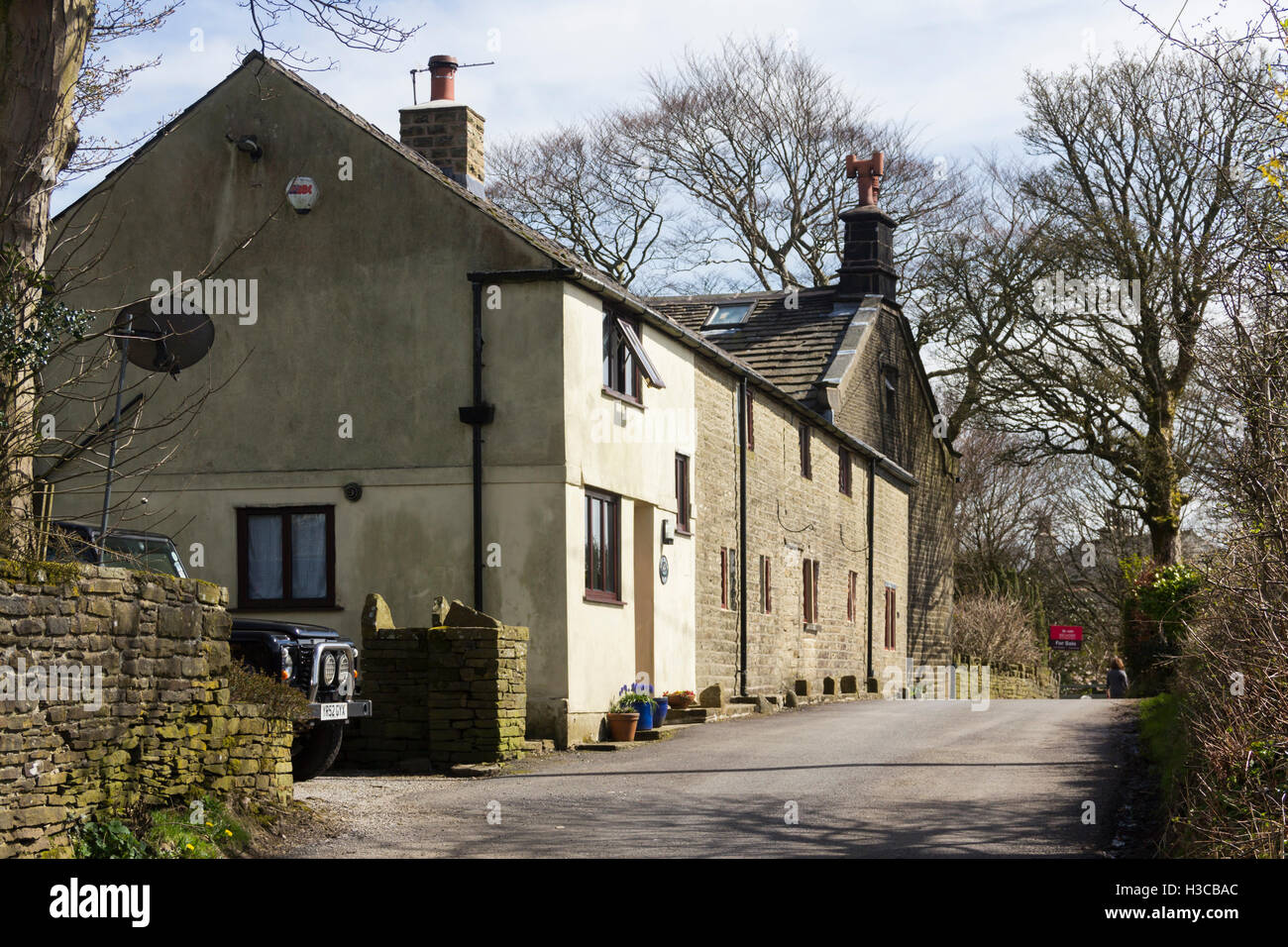Farm buildings alongside a house for sale on Edge Lane, Entwistle