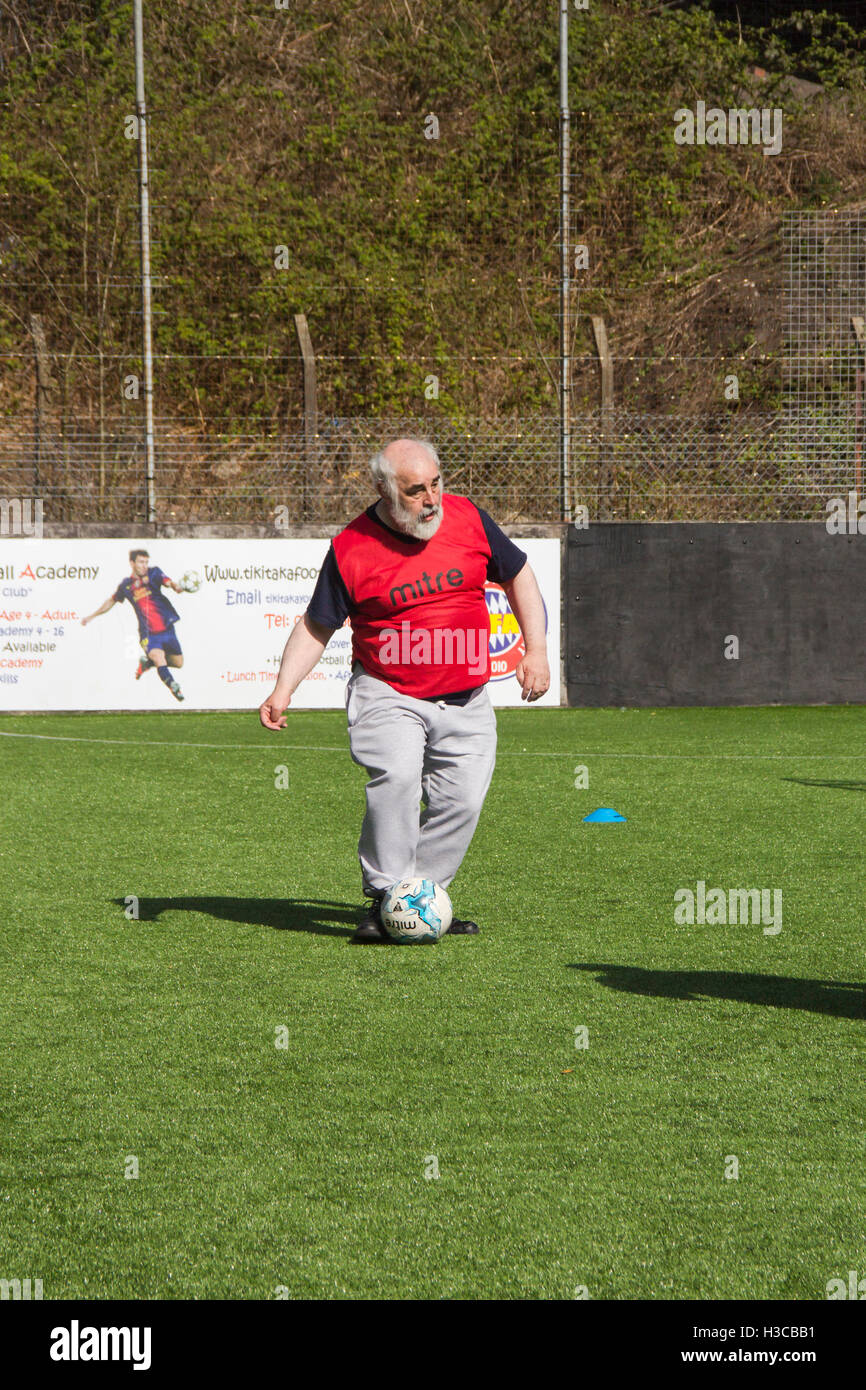 Middle-aged man taking part in a walking football session in Bolton, Lancashire, organised by Bolton Wanderers Community Trust Stock Photo