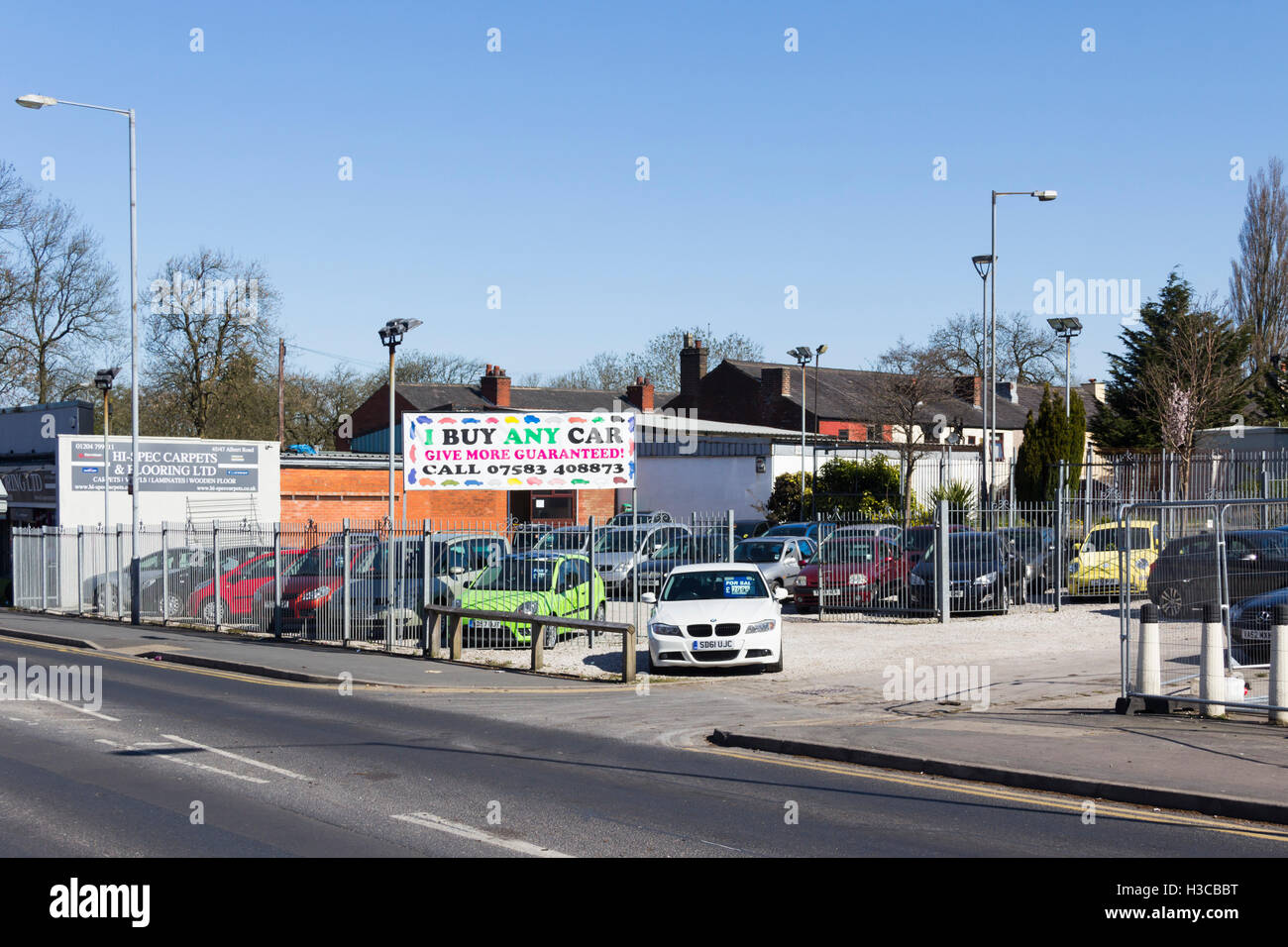 Small secondhand car dealer dealing in the lower end of the secondhand car market, advertising  the business as 'I Buy Any Car'. Stock Photo