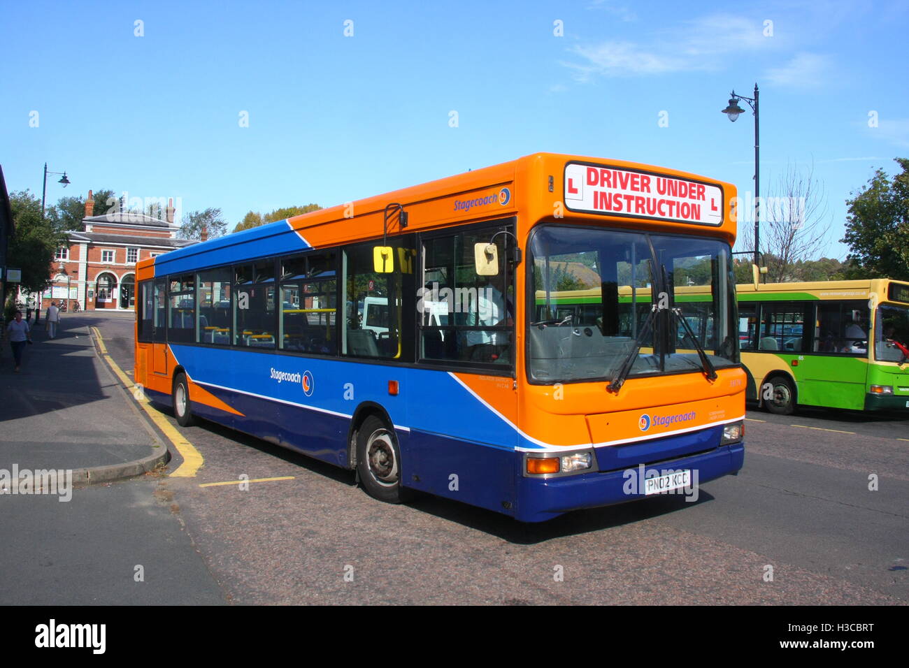 A SUNNY OFFSIDE VIEW OF A STAGECOACH DRIVER TRAINING SINGLE DECK BUS