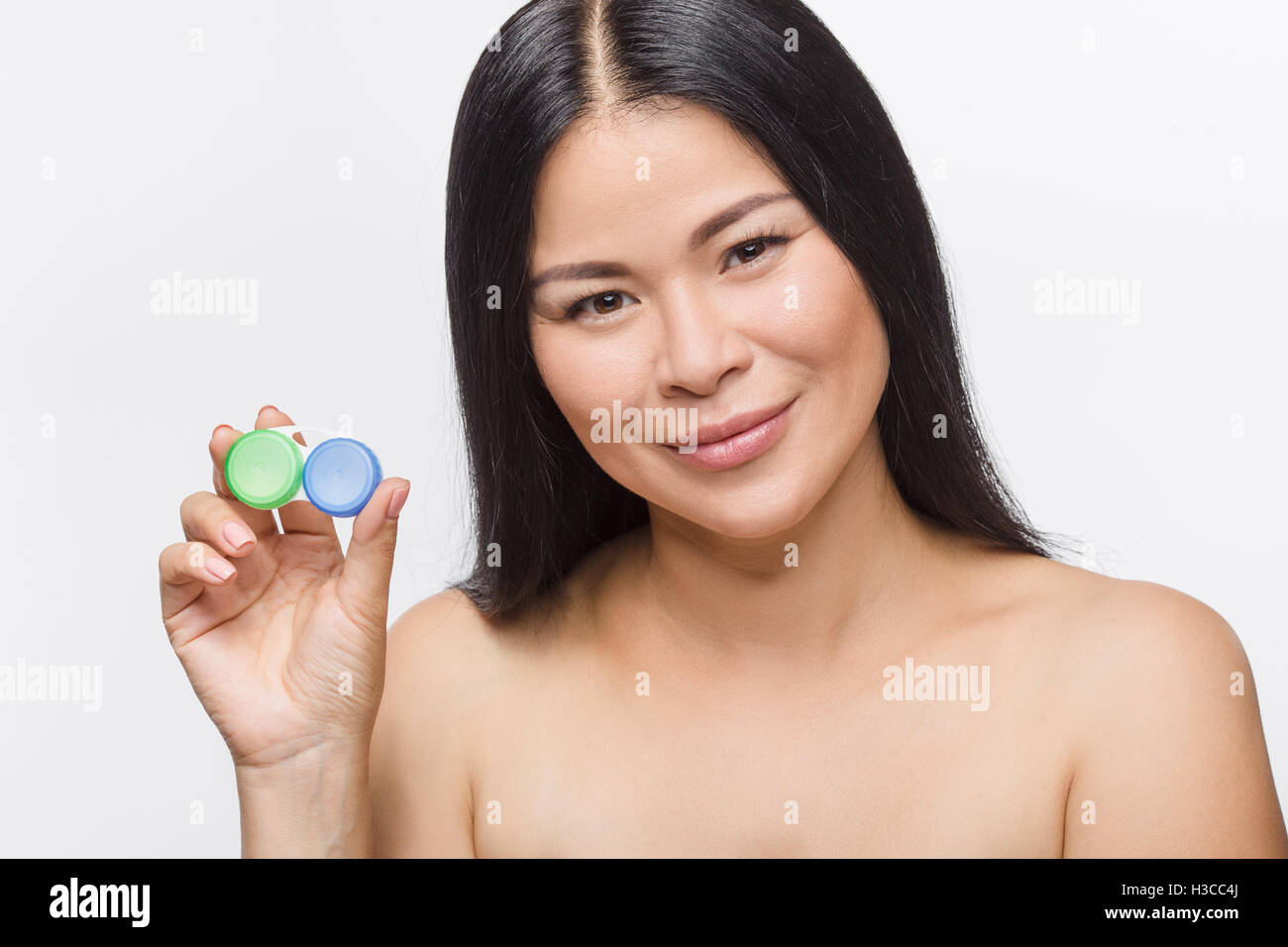 Woman with container for contact lenses Stock Photo