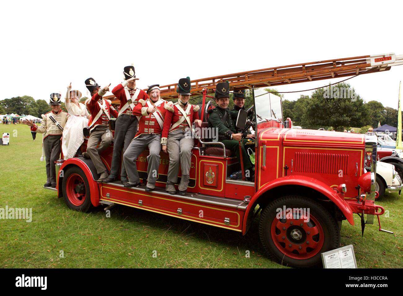 Cornwall 32nd Regiment of Foot pose aboard an old classic Fire Engine from Budleigh Salterton Stock Photo