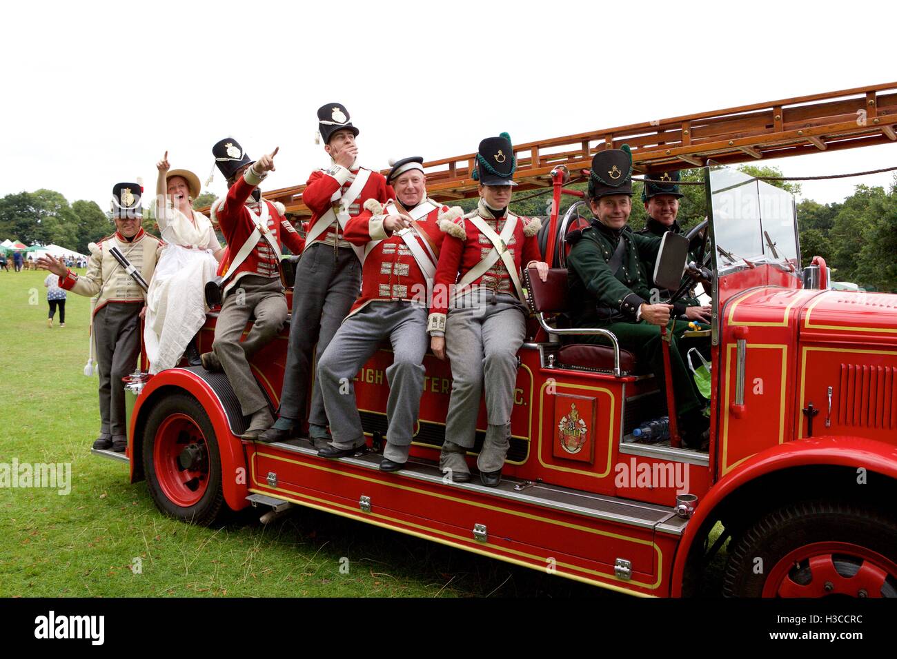 Cornwall 32nd Regiment of Foot pose aboard an old classic Fire Engine from Budleigh Salterton Stock Photo