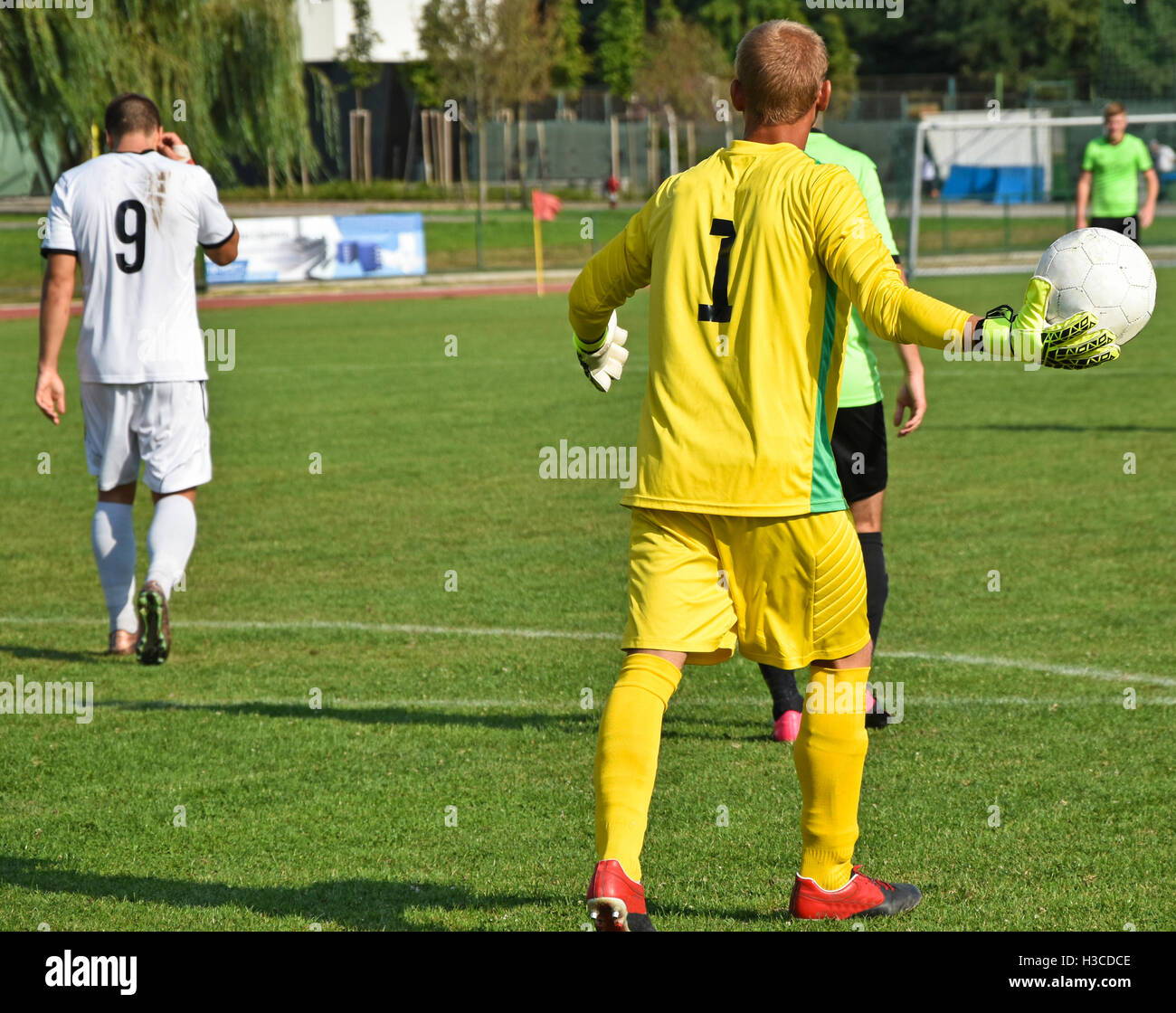 Soccer goalkeeper throws out the ball on the match Stock Photo Alamy