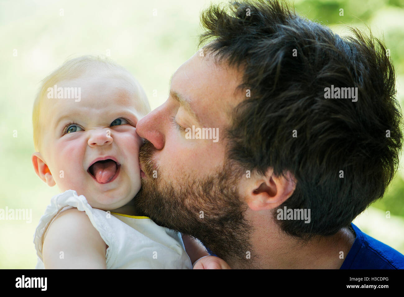 Father kissing baby's cheek Stock Photo