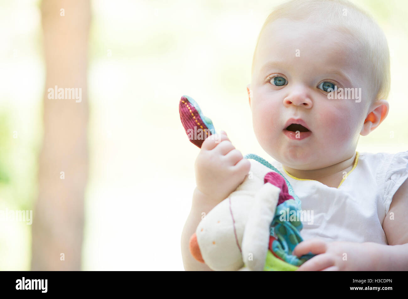 Baby holding stuffed toy, portrait Stock Photo