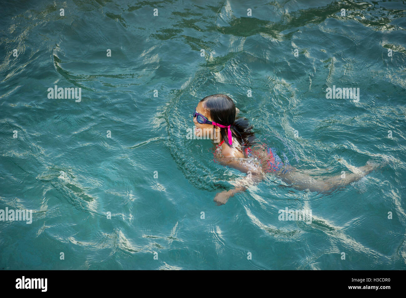 Girl swimming in pool Stock Photo