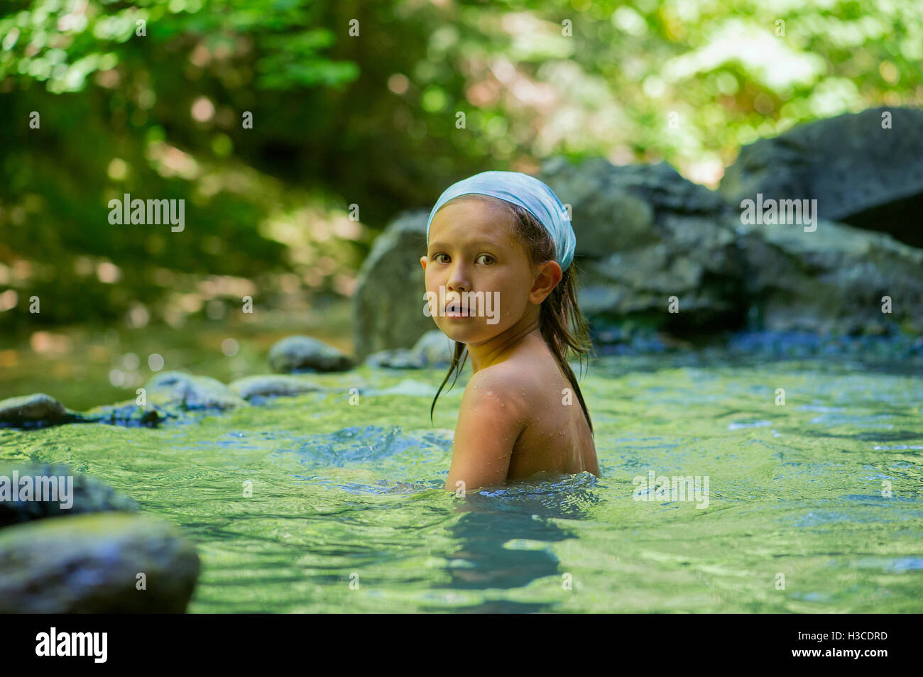 Girl bathing in natural pool Stock Photo