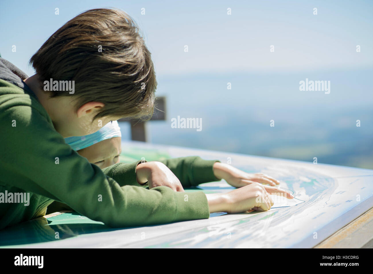 Young siblings studing map at scenic overlook Stock Photo