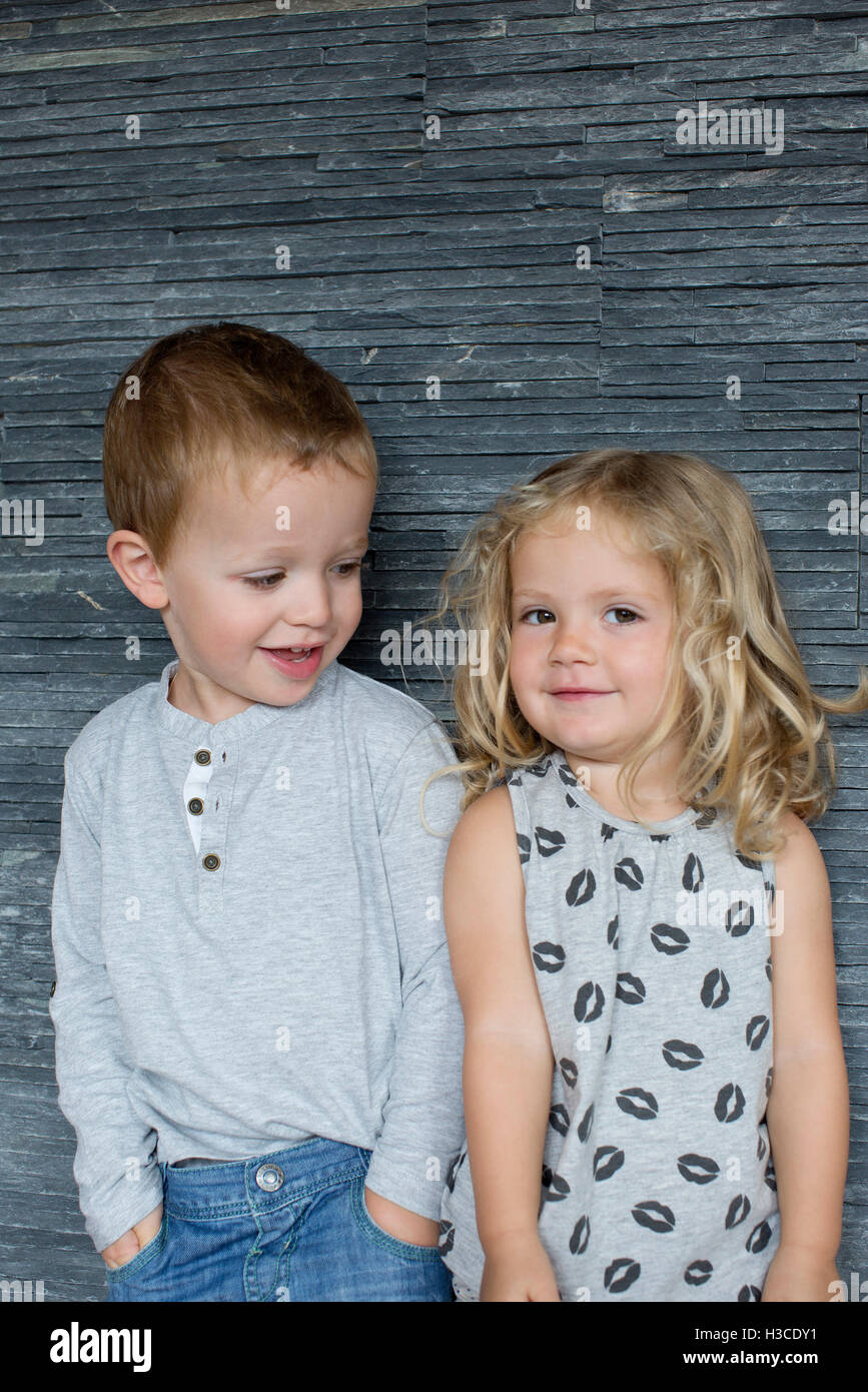 Little boy and little girl standing side by side, portrait Stock Photo
