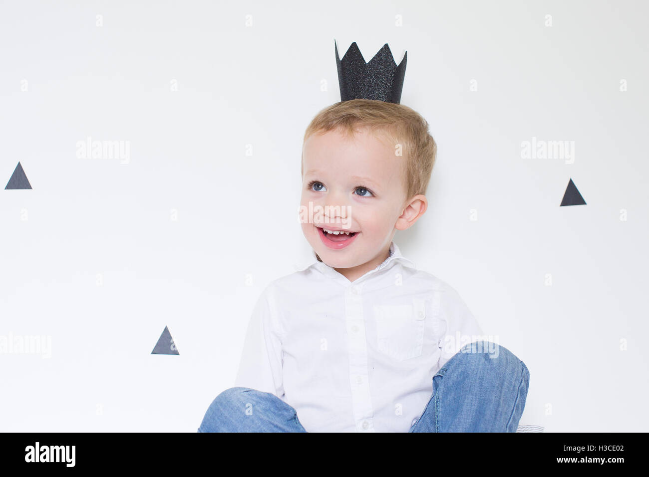 Little boy wearing paper crown Stock Photo