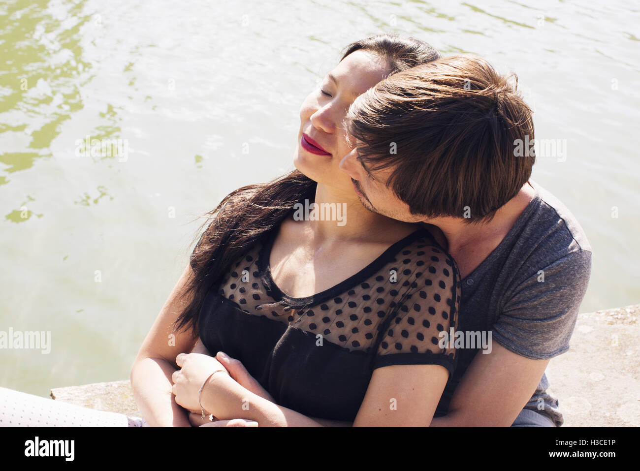 Couple relaxing together outdoors Stock Photo