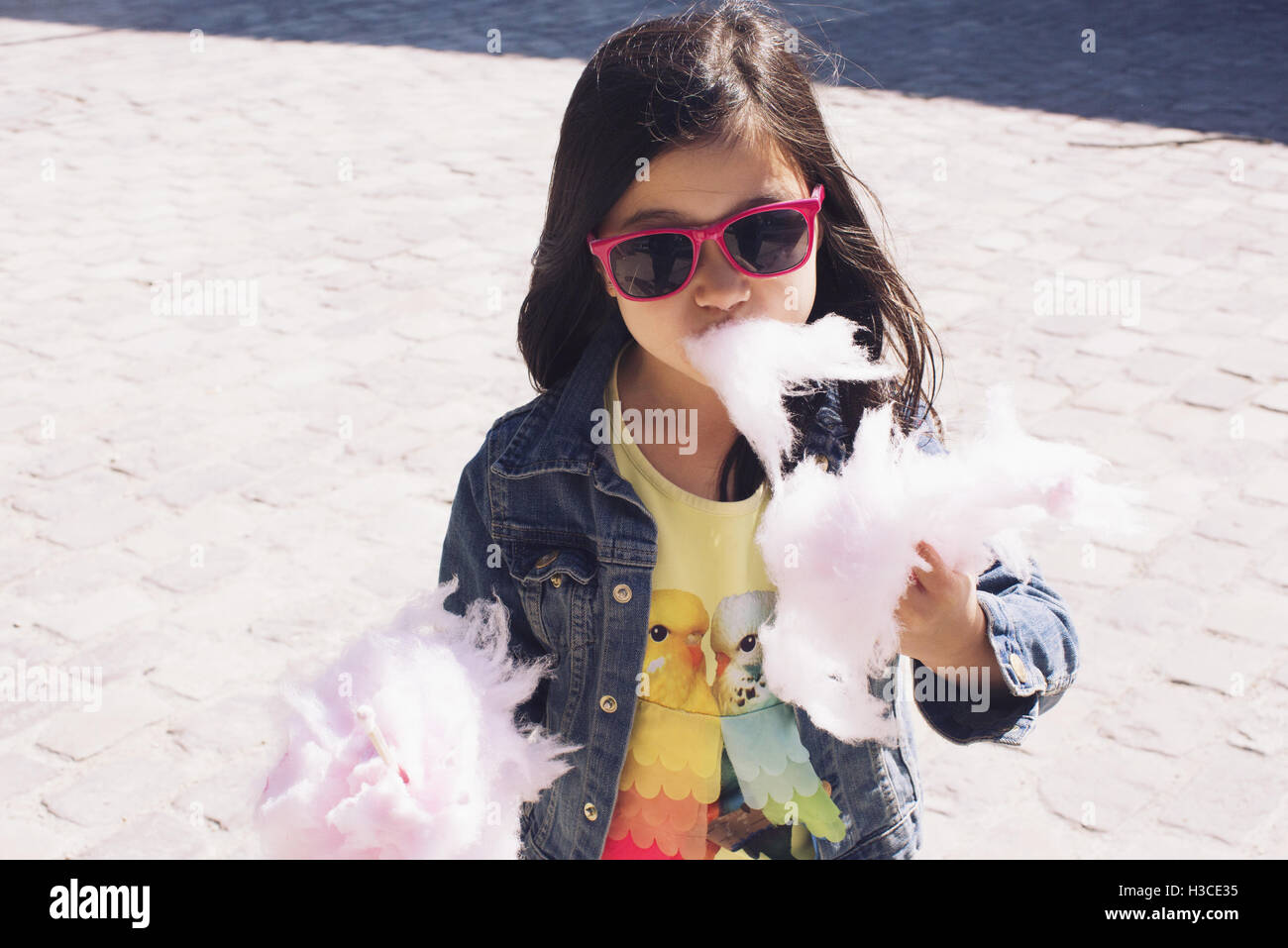 Little girl eating cotton candy Stock Photo