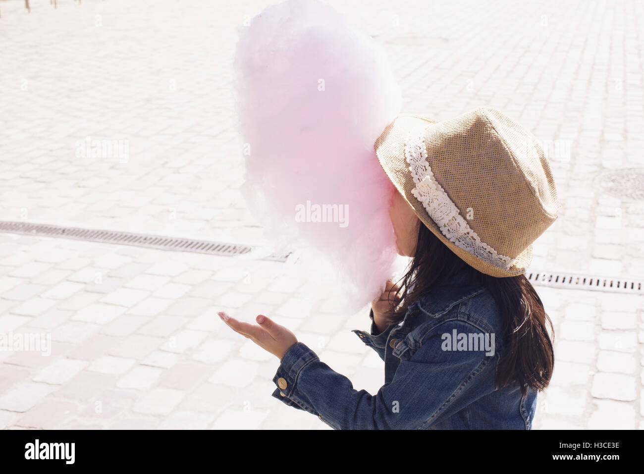 Girl eating cotton candy Stock Photo