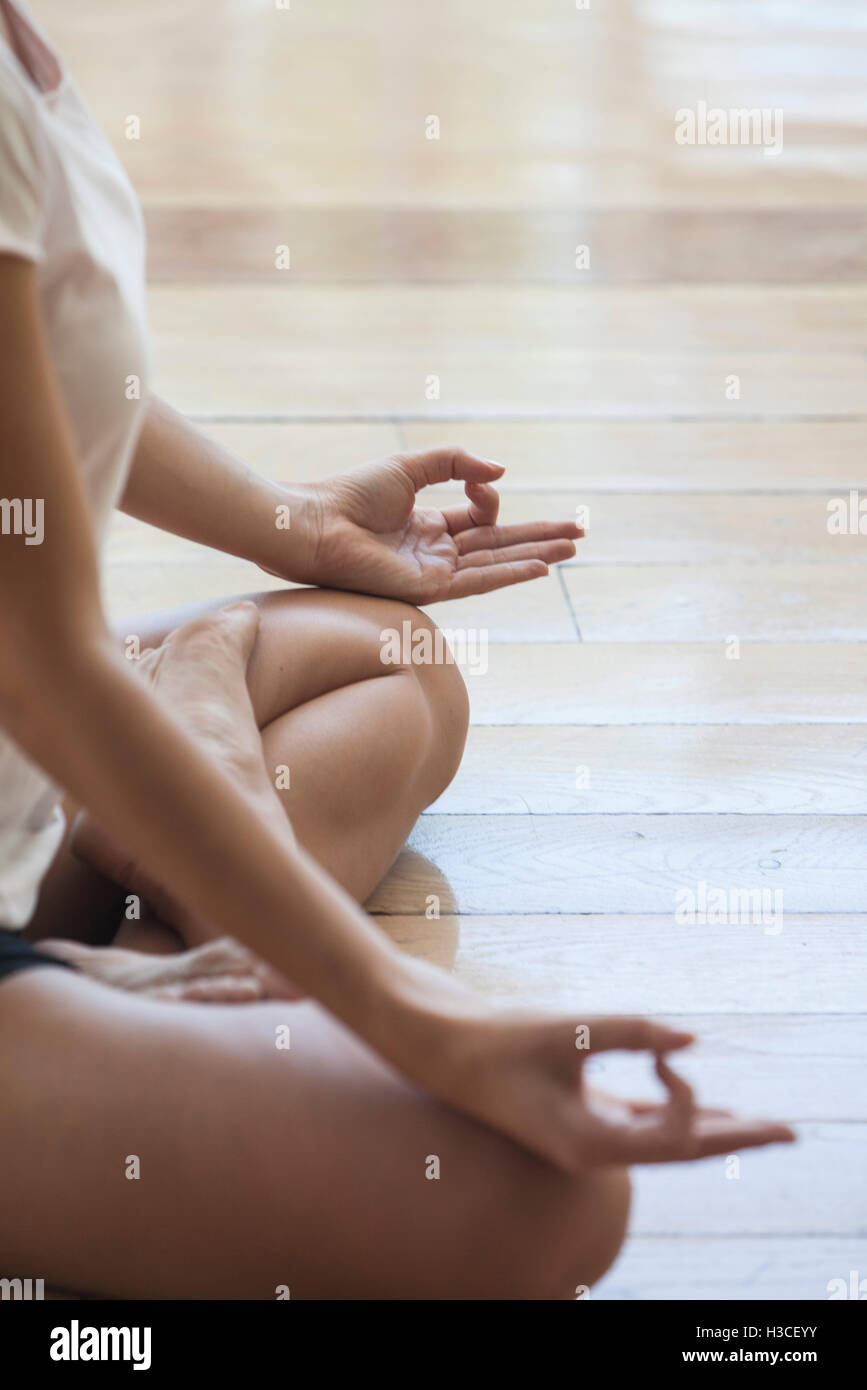 Woman seated in yoga lotus position, cropped Stock Photo