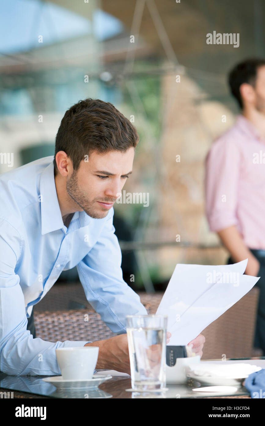 Businessman reviewing documents Stock Photo